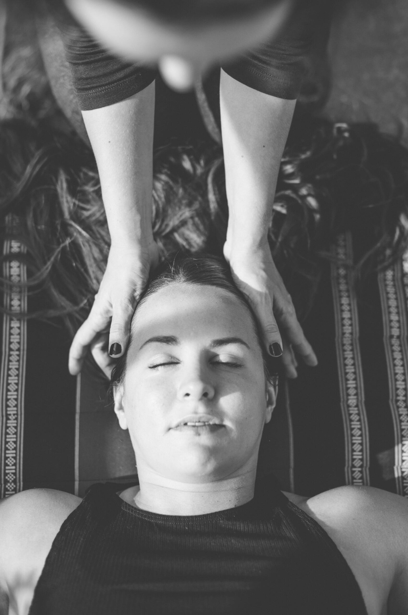 Therapist gently cradles a client’s head during a relaxing massage at Venet Massage & Wellness in Phinney Ridge, Seattle.